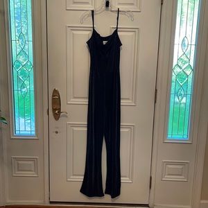 Shimmery jumpsuit with black over blouse